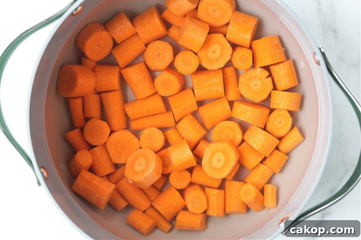 cut carrots in a pot with water