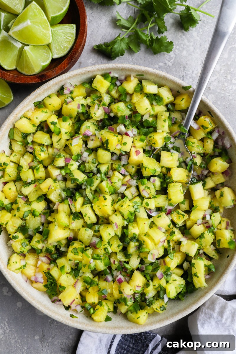 A large bowl filled with fresh pineapple salsa