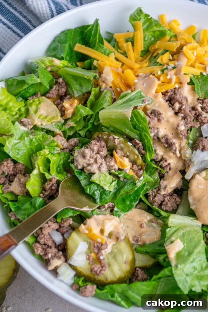 Fork with a bite of big mac salad.