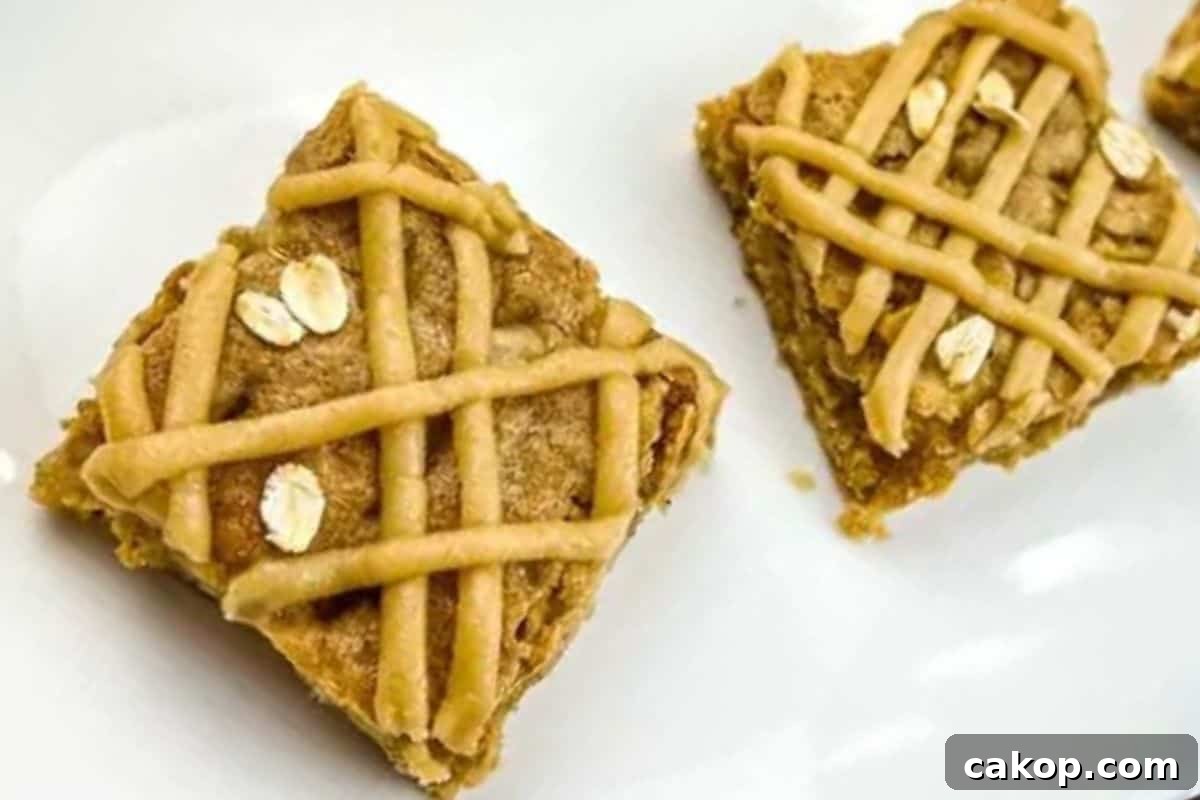 Two brown butter apple blondies were placed on a white surface.