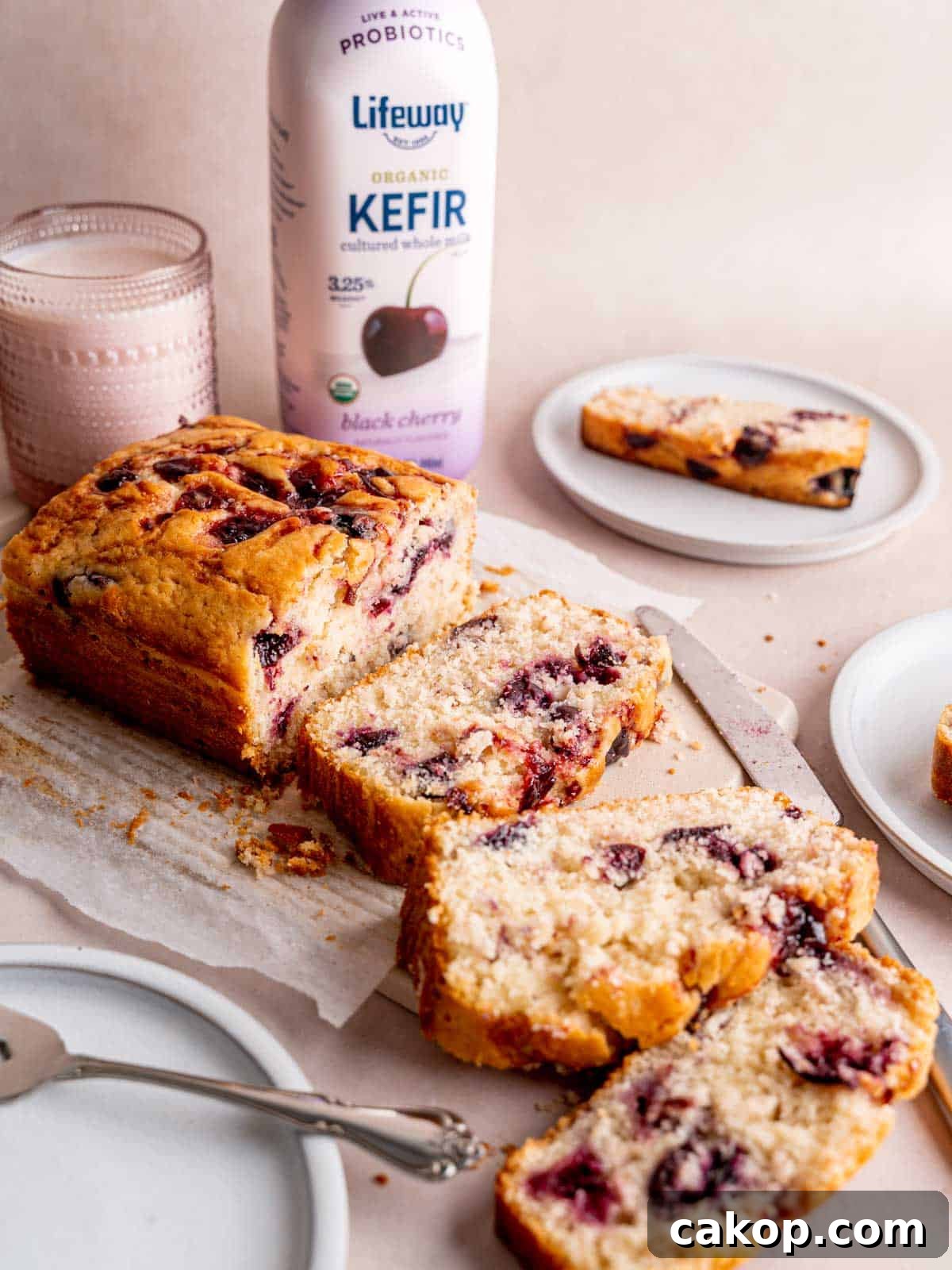Cherry Loaf Cake Recipe: Moist Homemade Cherry Bread 8 A cherry cake cut into slices next to a bottle of Lifeway Black Cherry Kefir.
