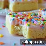 Sprinkle Sugar Cookie Bars Recipe — Soft, Chewy, Crowd-Pleasing 7 sugar cookie bars with bite missing