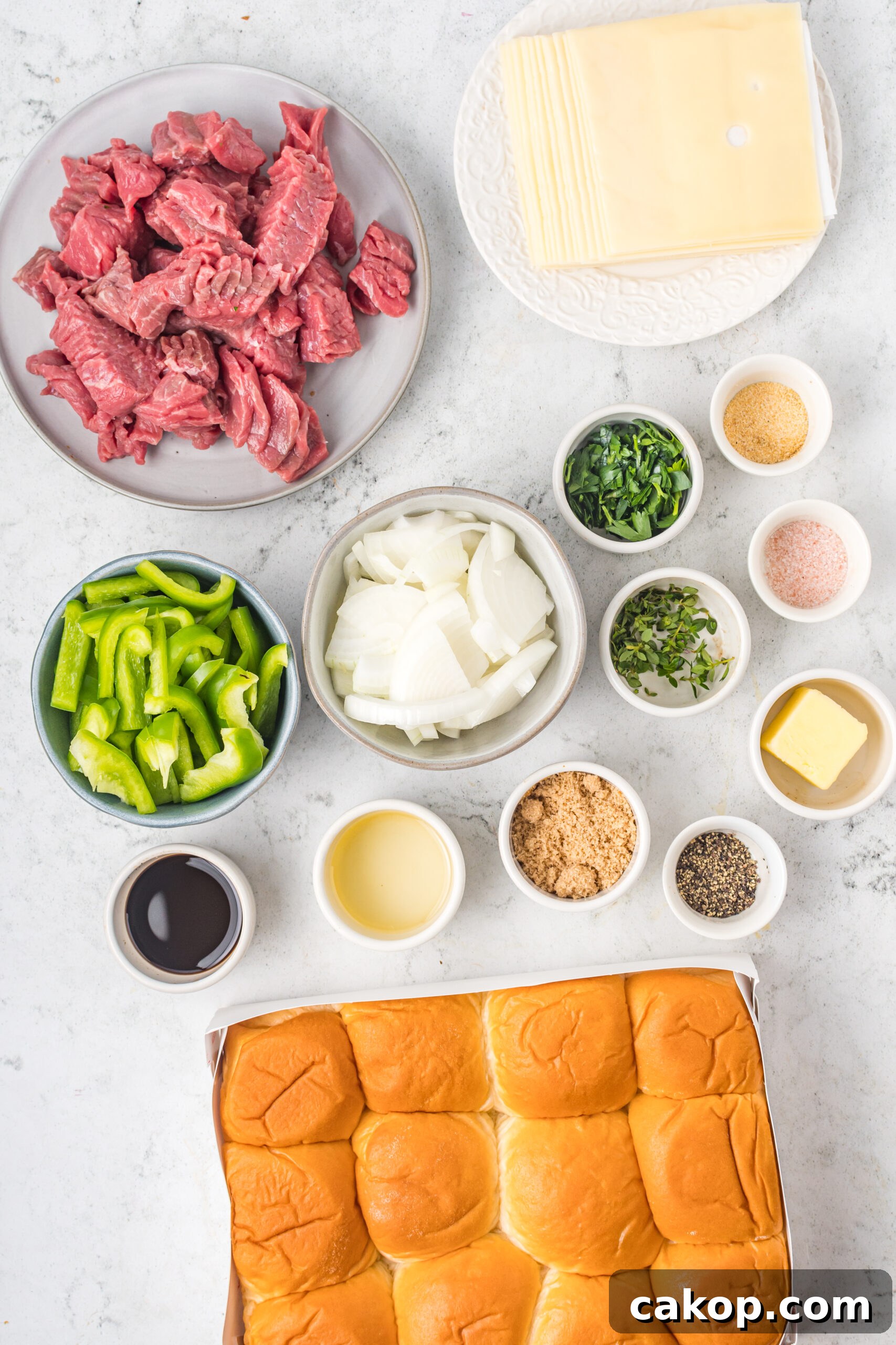 Philly Cheesesteak Sliders Recipe: Savory Mini Sandwiches for Game Day 6 Overhead shot of ingredients needed to make Philly Cheesesteak Sliders.