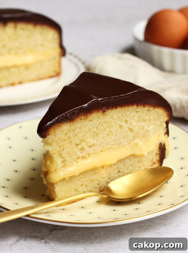 Classic Boston Cream Pie Recipe: Creamy Custard & Chocolate Glaze 5 slice of Boston cream pie on a plate