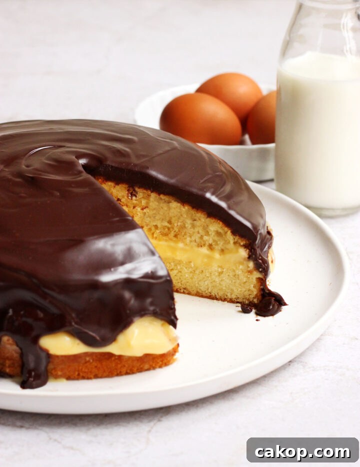 Classic Boston Cream Pie Recipe: Creamy Custard & Chocolate Glaze 6 Boston cream pie sliced
