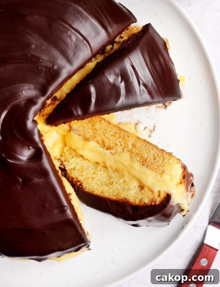 Classic Boston Cream Pie Recipe: Creamy Custard & Chocolate Glaze 8 Boston cream pie sliced