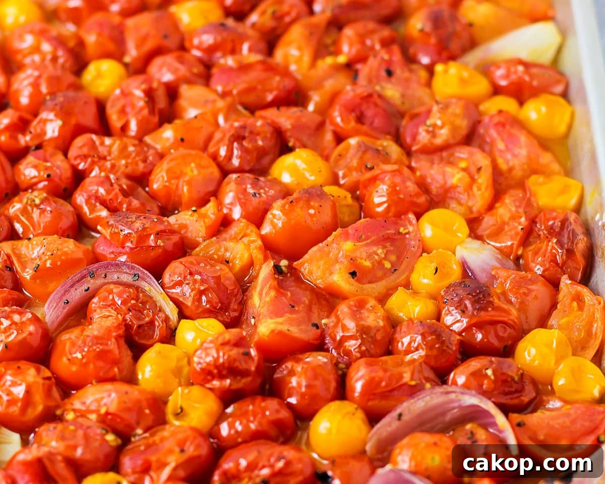 A sheet pan filled with roasted tomatoes.