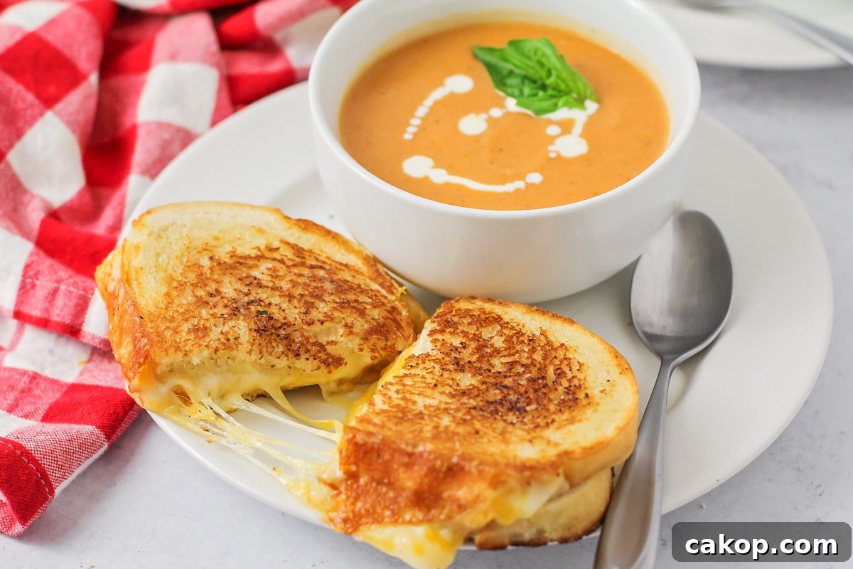 A bowl of soup served with grilled cheese sandwich.