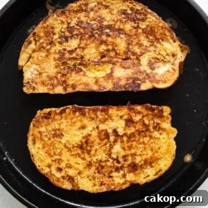 Bananas Foster French Toast Recipe for Brunch or Dessert 10 Two slices of french toast in a skillet.