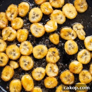 Bananas Foster French Toast Recipe for Brunch or Dessert 11 Sliced bananas are being fried in a skillet.