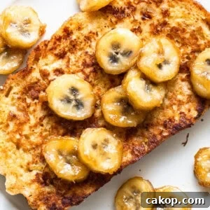Bananas Foster French Toast Recipe for Brunch or Dessert 12 French toast with banana slices on a plate.