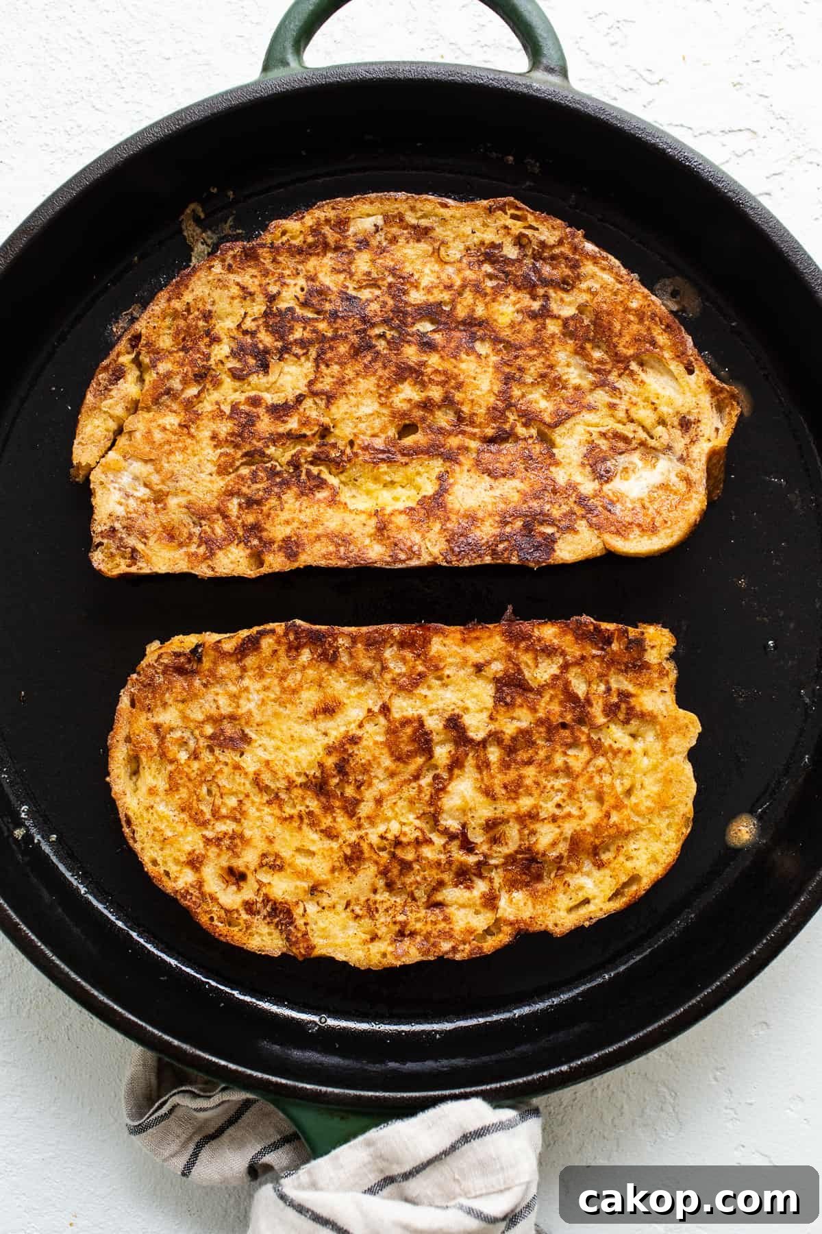 Bananas Foster French Toast Recipe for Brunch or Dessert 4 Two slices of french toast in a skillet.
