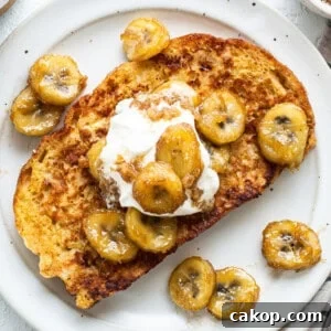 Bananas Foster French Toast Recipe for Brunch or Dessert 7 A plate of french toast with bananas and whipped cream.