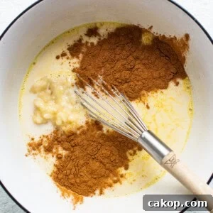 Bananas Foster French Toast Recipe for Brunch or Dessert 8 A bowl with cinnamon, sugar, and a whisk.
