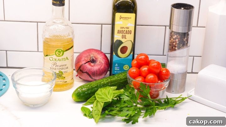 Cucumber, tomato, and onion salad with cottage ingredients - cucumbers, tomatoes, onions, white wine vinegar, olive oil, salt, pepper, basil, parsley, and sugar.