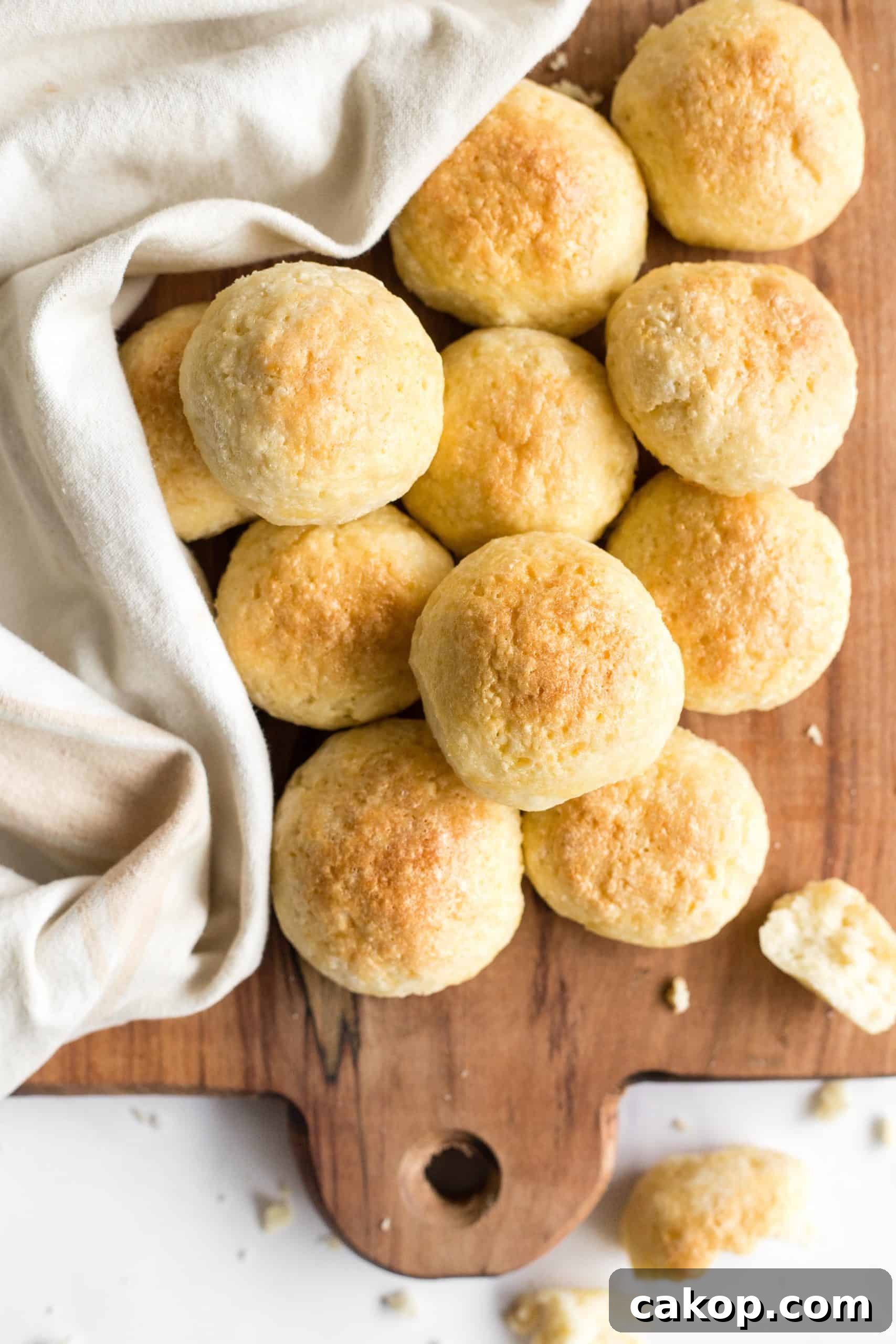Soft Gluten-Free Yeast Rolls (Dairy-Free) Top down view of gluten-free yeast rolls on a wooden board.