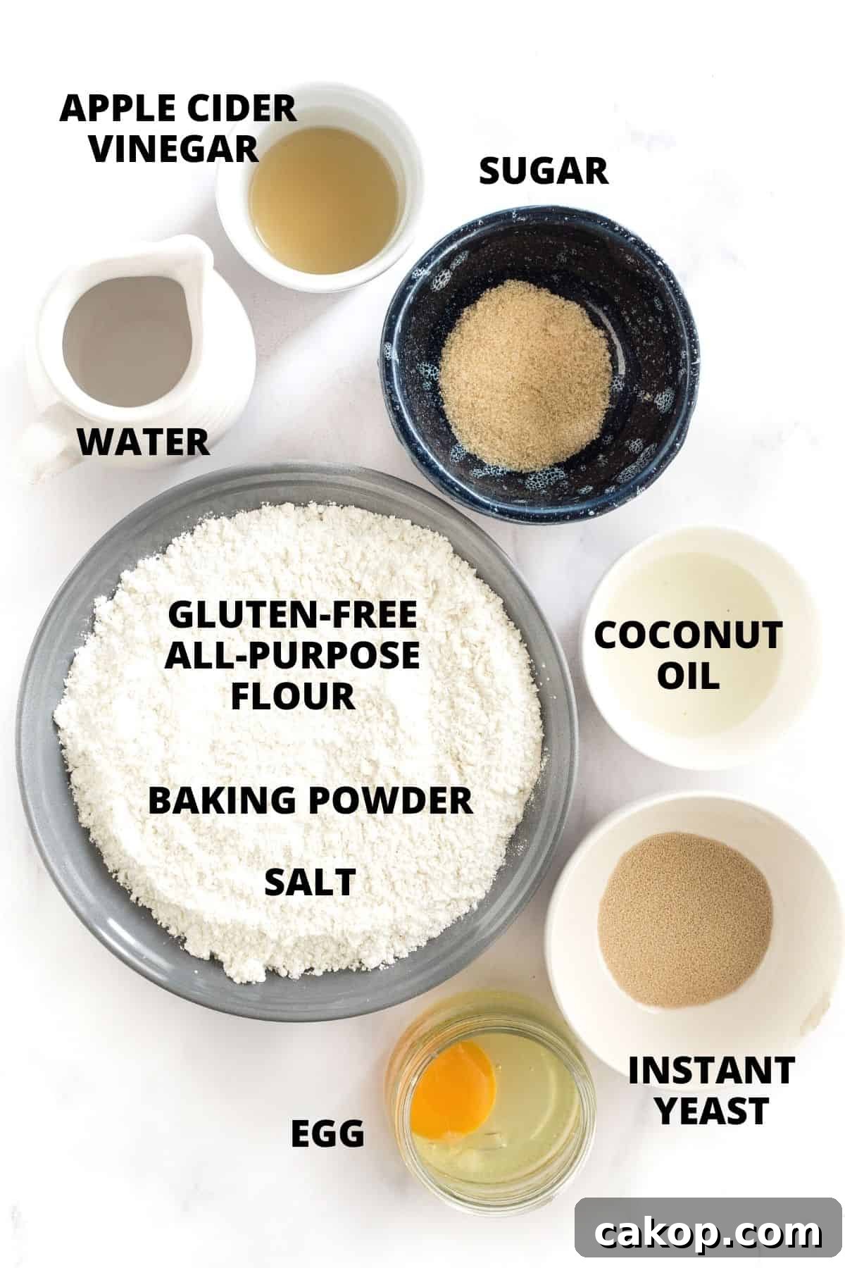 Soft Gluten-Free Dinner Rolls Recipe (Dairy-Free) Labeled ingredients for gluten-free dinner rolls recipe laid out on marble board.