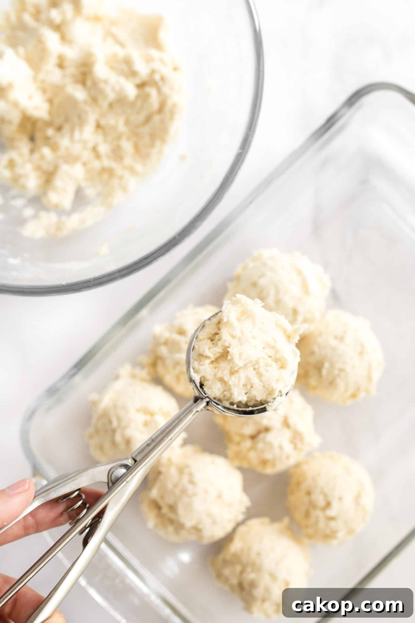 Gluten and Dairy-Free Dinner Rolls Scooping bread dough with an ice cream scoop.