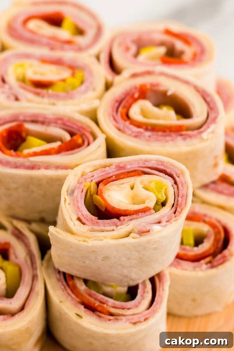 closeup of Italian Pinwheels on wooden serving board.