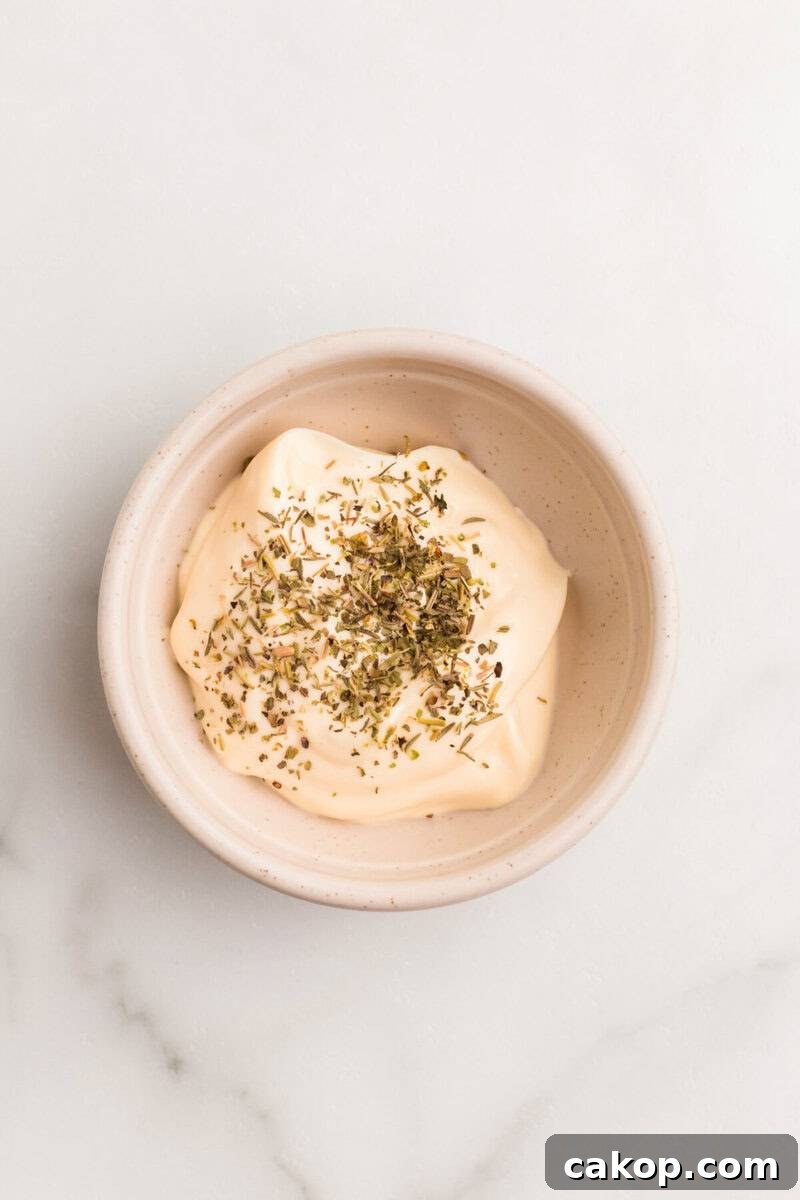 mayo and Italian Seasoning in a mixing bowl for the spread.