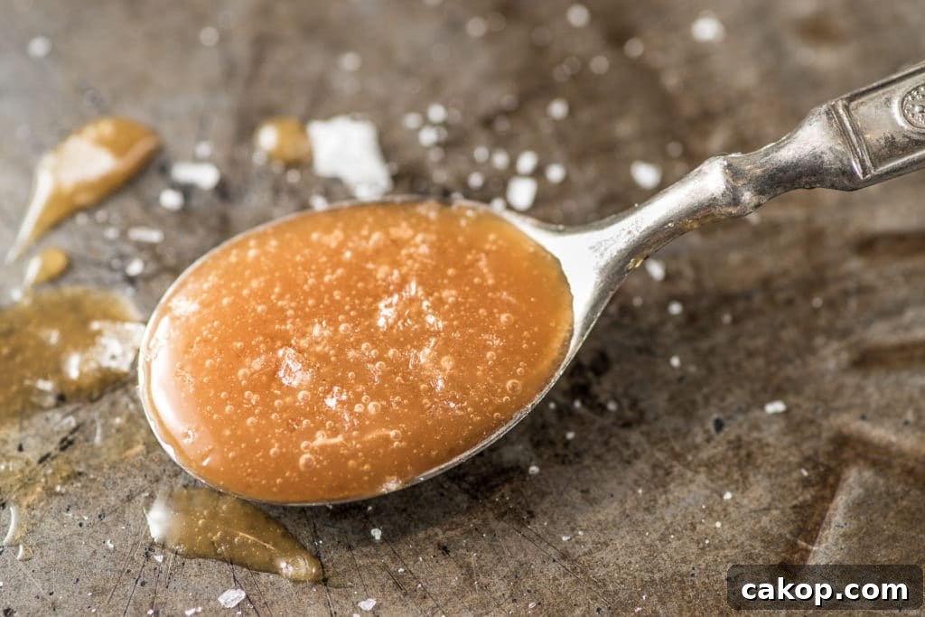 A spoon full of keto caramel sauce.