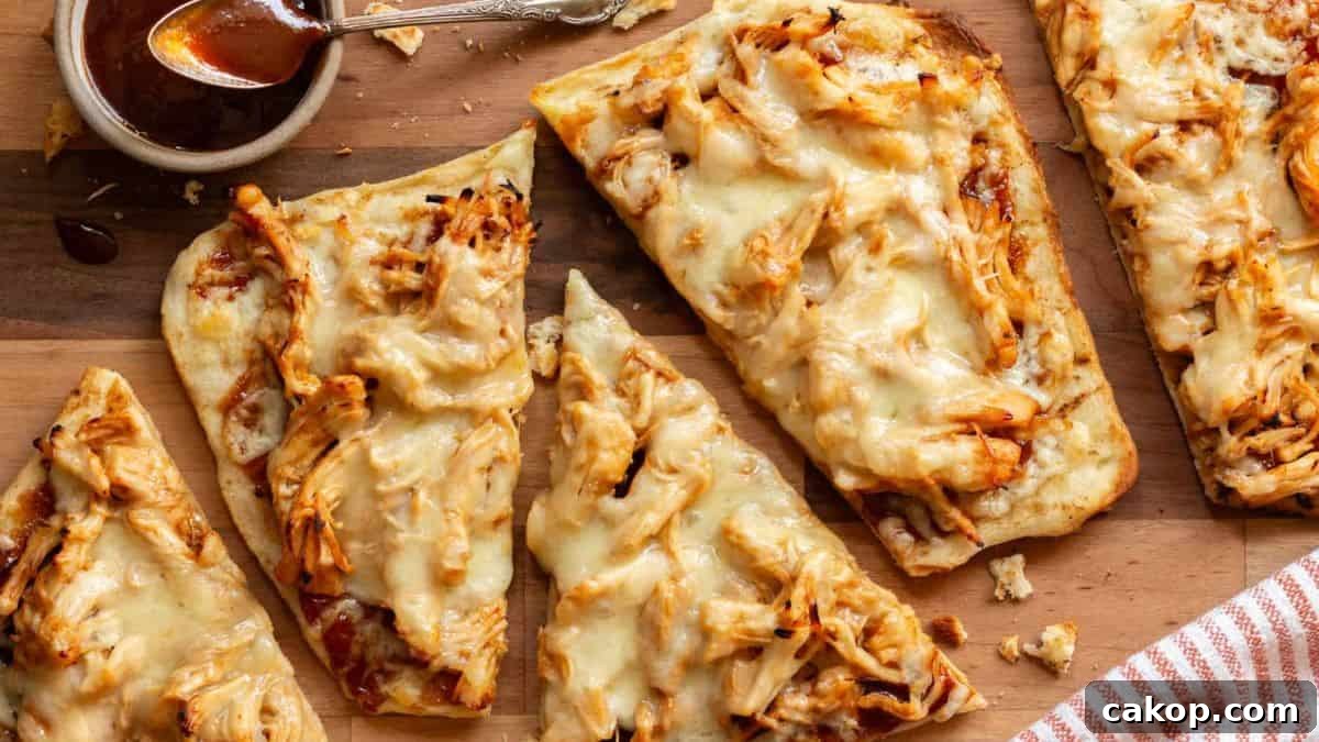 11 Quick Chicken Dinner Recipes for Weeknight Meals 11 BBQ Chicken Flatbread served on a board with BBQ sauce on the side.