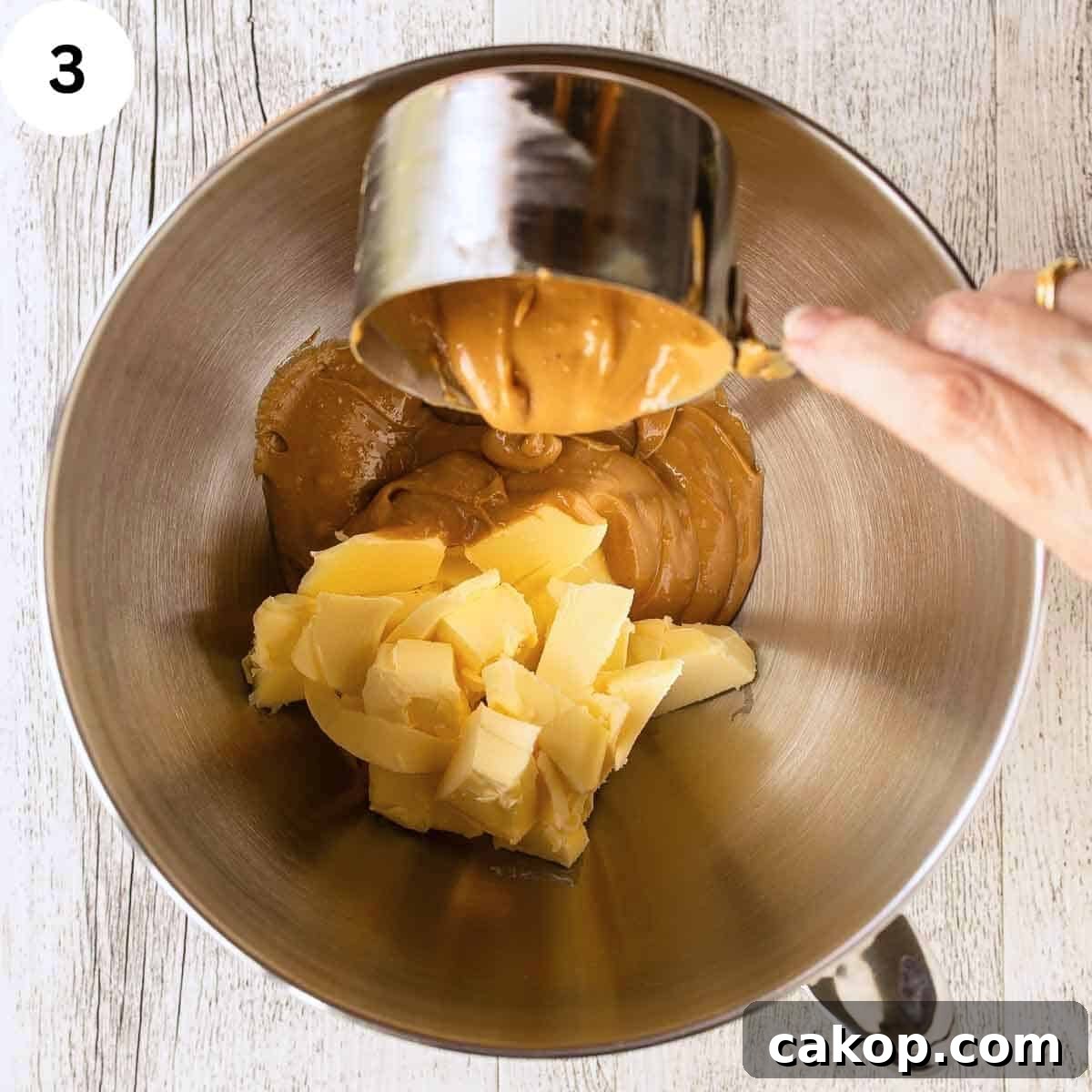 Decadent Chocolate Peanut Butter Cake Recipe 6 Pouring peanut butter into a bowl container butter.