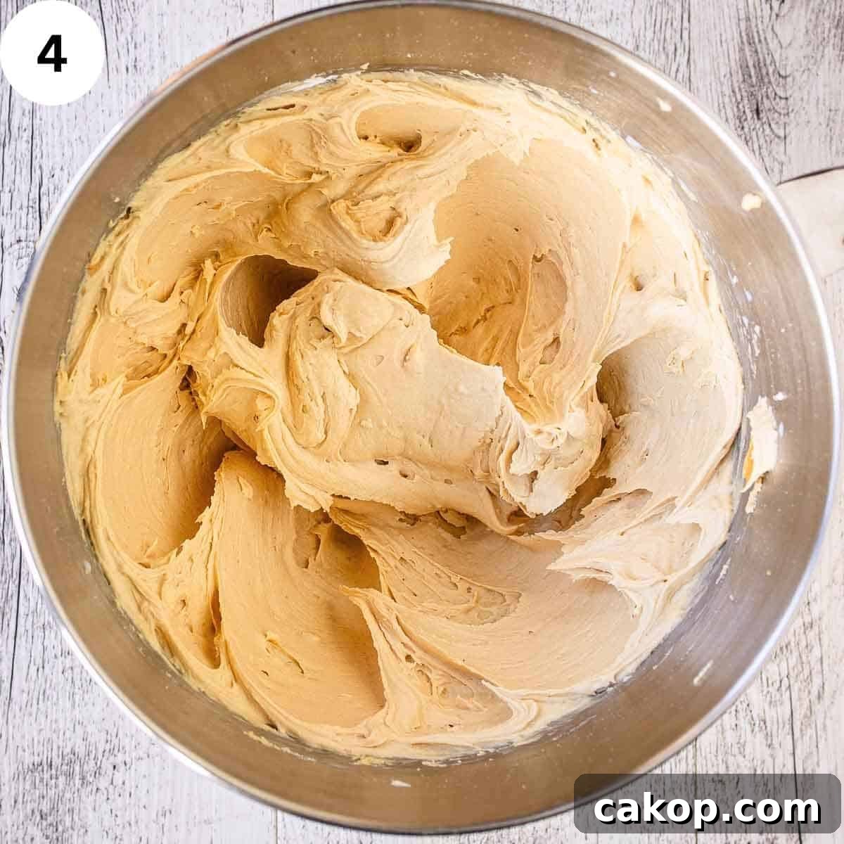 Decadent Chocolate Peanut Butter Cake Recipe 7 Light and fluffy buttercream in a stainless steel bowl.