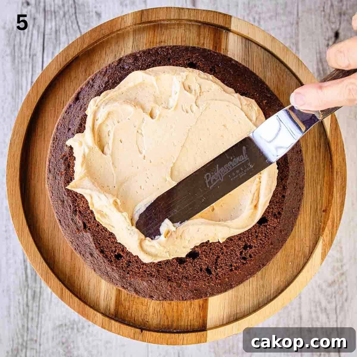 Decadent Chocolate Peanut Butter Cake Recipe 8 Spreading buttercream onto a chocolate cake.