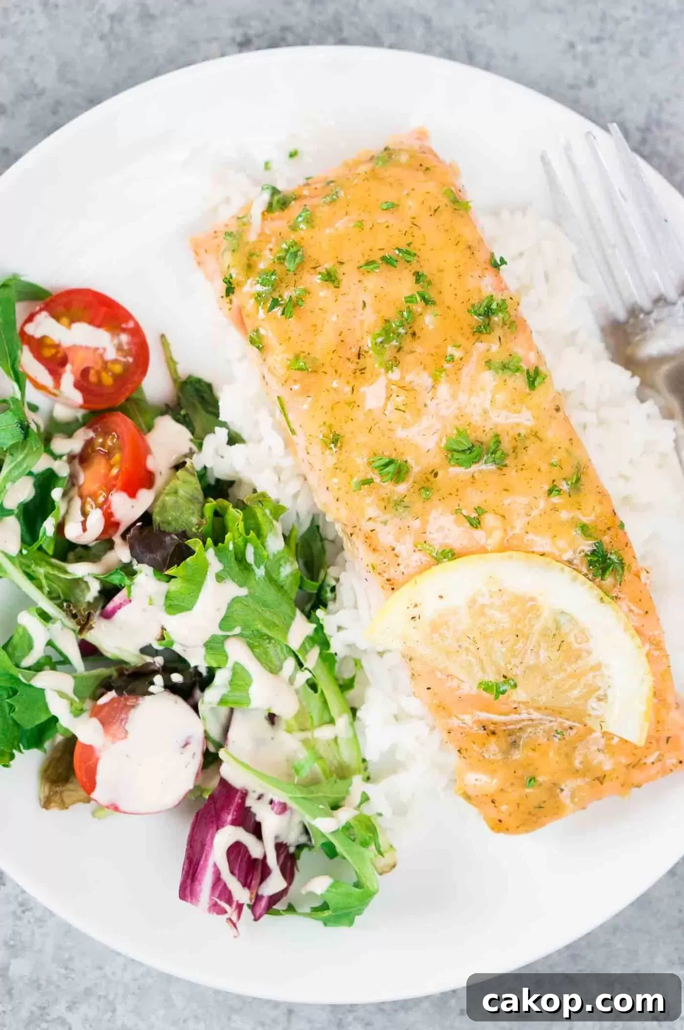 Glazed Honey Dijon Salmon with a side salad on a white plate