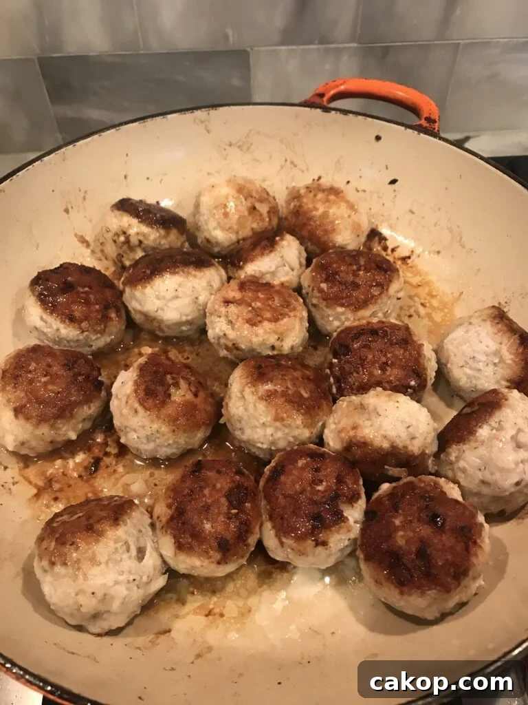 One-Pan Italian Meatball Skillet with Tomato Sauce and Pasta 4 Meatballs pan frying in a skillet