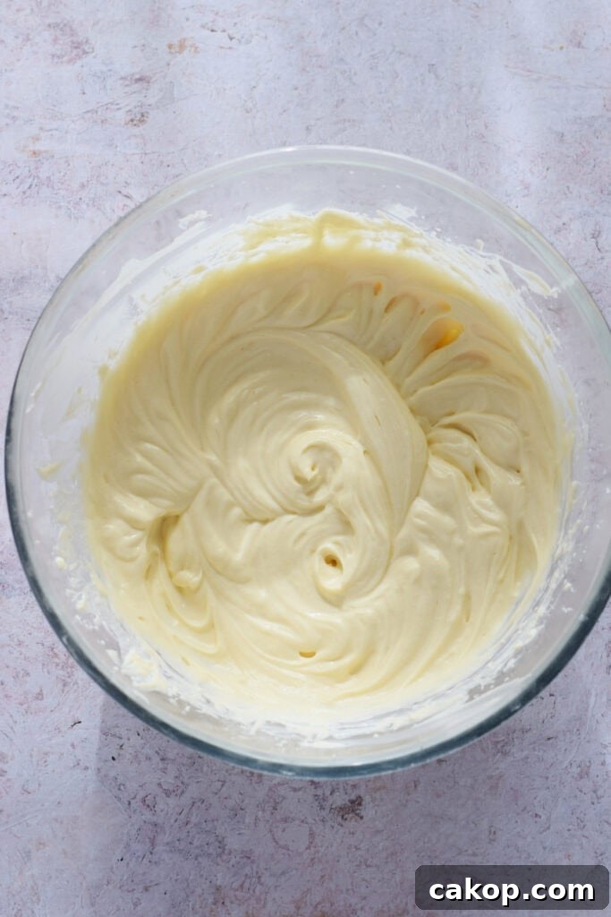 Cheesecake batter in a glass bowl.
