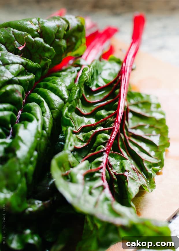 Swiss Chard and Walnut Pesto Pasta Recipe for Flavorful Weeknights 3 Several stalks of Swiss chard on a wooden surface.