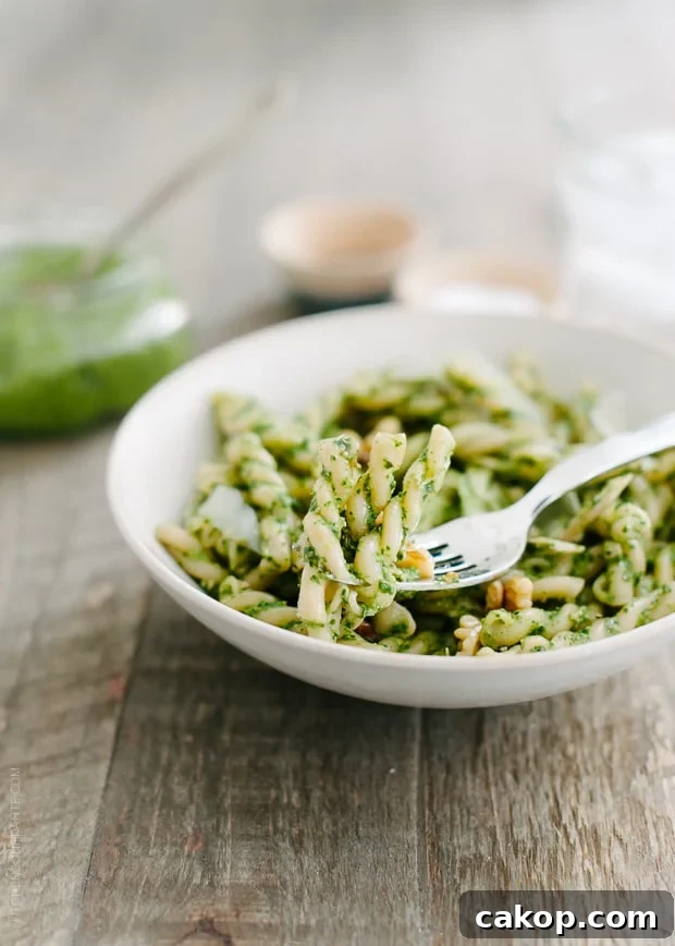 Swiss Chard and Walnut Pesto Pasta Recipe for Flavorful Weeknights 8 A white bowl filled with pesto pasta.