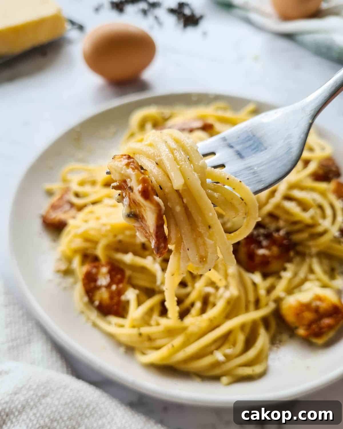 close up forkful of spaghetti carbonara