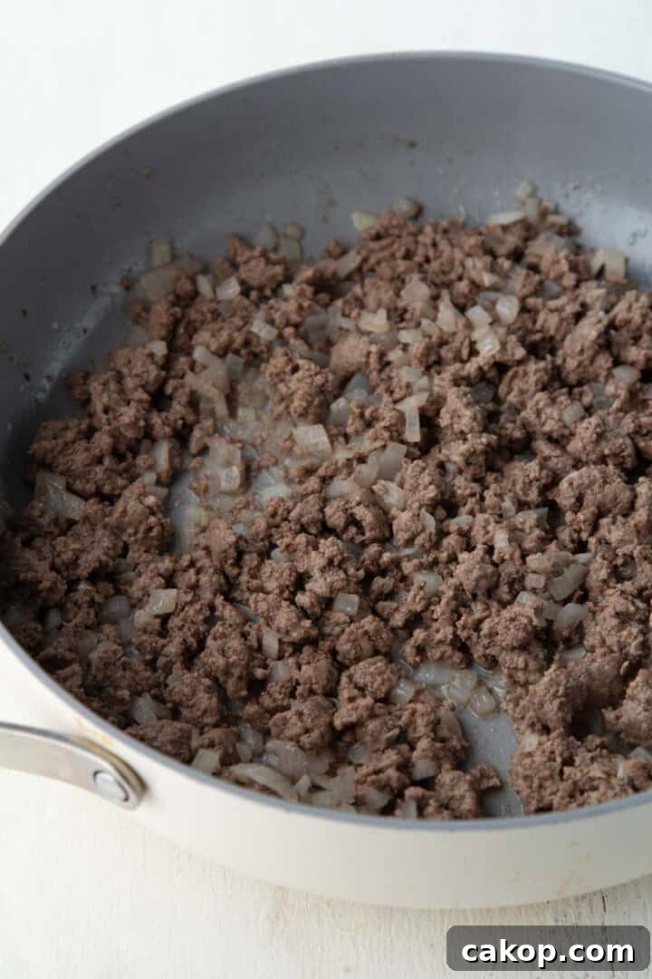 ground beef and onion in a skillet.