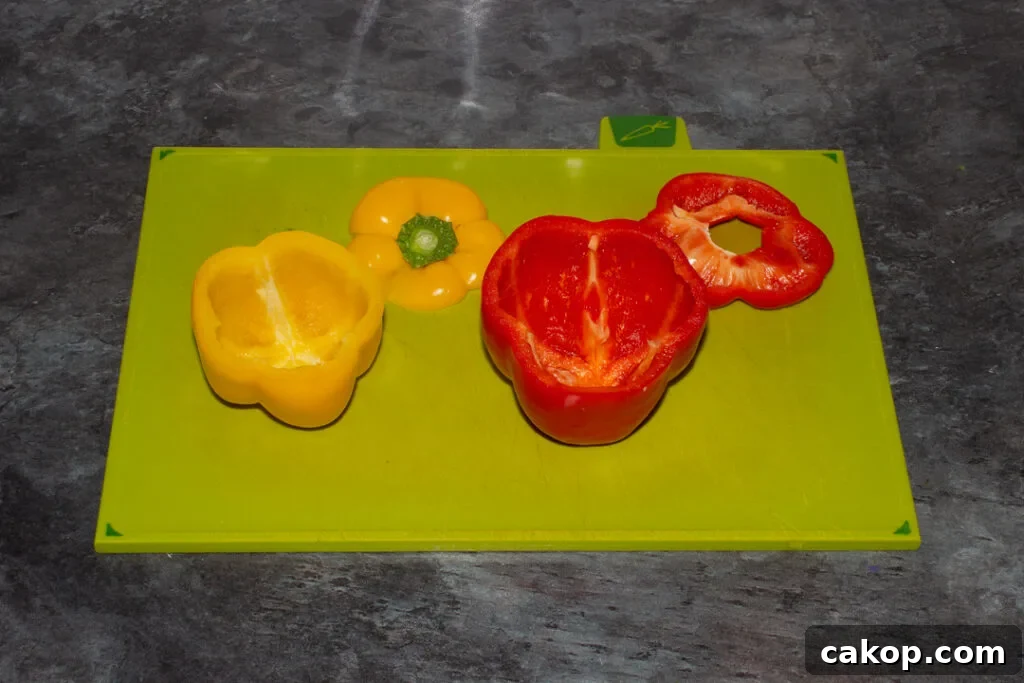Hollowed out bell peppers on a chopping board