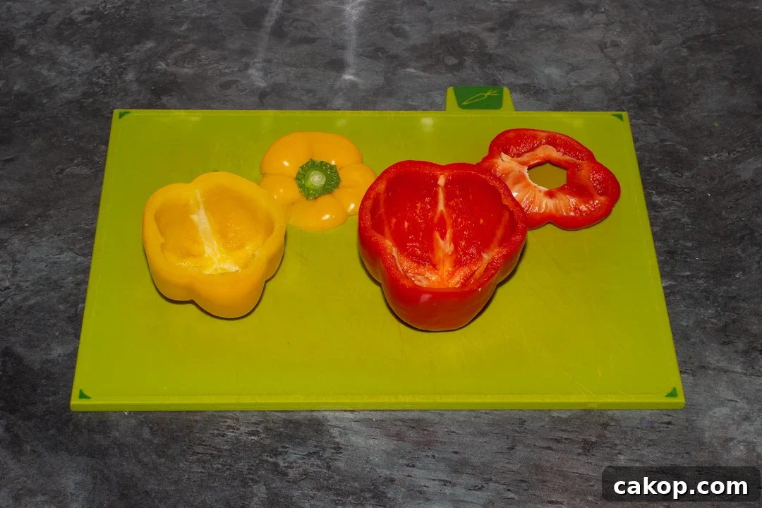 Hollowed out bell peppers on a chopping board