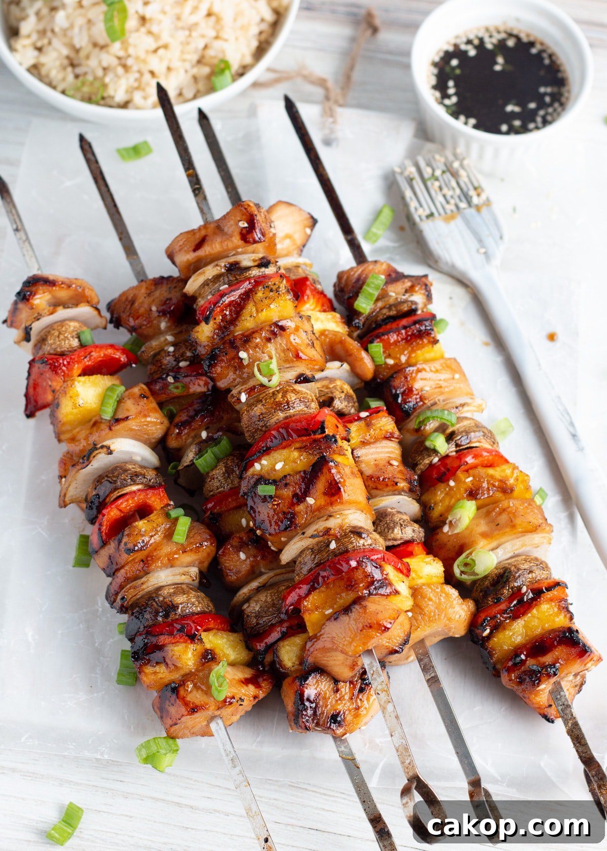 Grilled Teriyaki Chicken and Pineapple Kabobs Recipe 2 Picture of cooked skewers with chicken, pineapple, mushrooms, onion and peppers.
