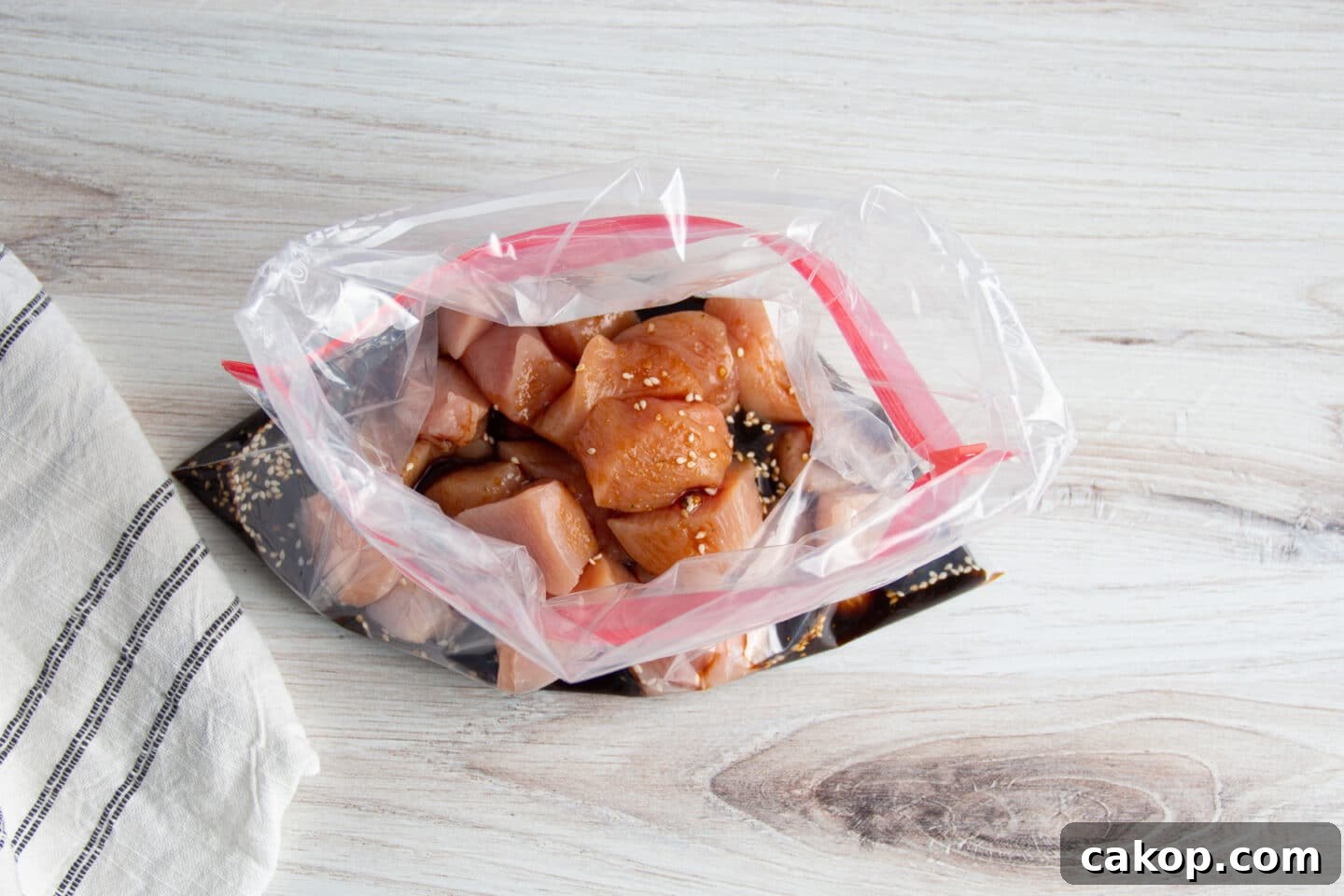 Grilled Teriyaki Chicken and Pineapple Kabobs Recipe 5 Picture of chicken in zip-top bag with teriyaki sauce.