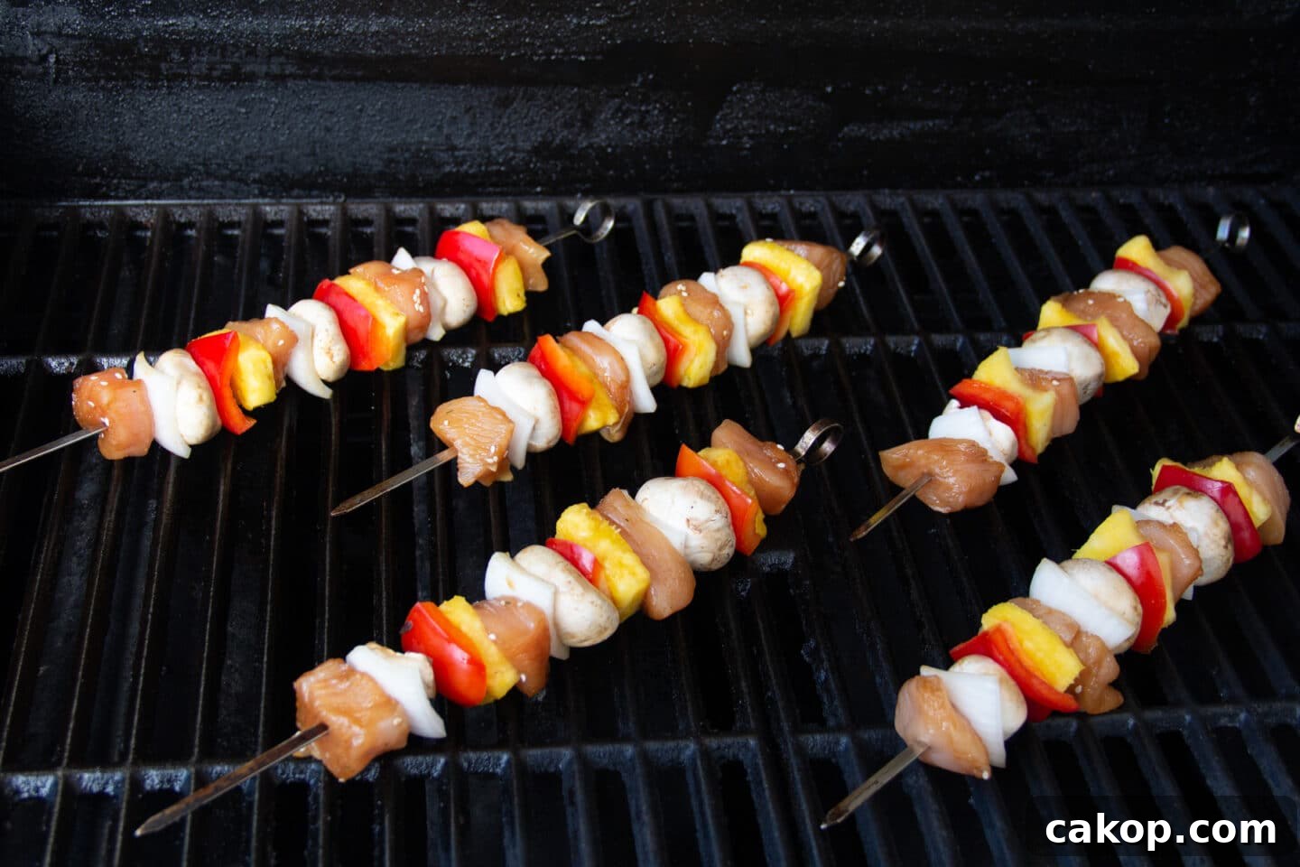 Grilled Teriyaki Chicken and Pineapple Kabobs Recipe 7 Picture of skewers on grill.