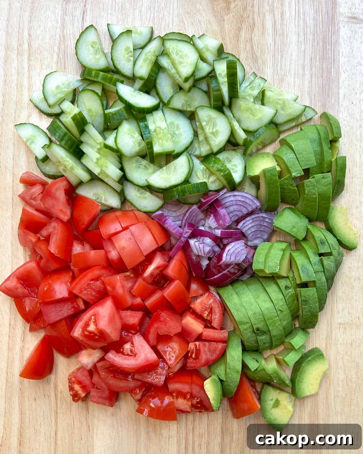 Creamy Avocado and Tomato Salad with Lime and Basil 4 Chopped veggies on a cutting board.