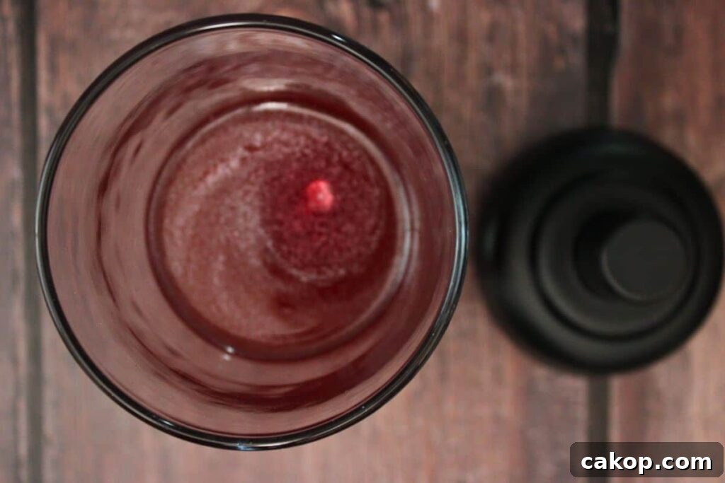 add vodka, triple sec, juices, and luster dust to cocktail shaker