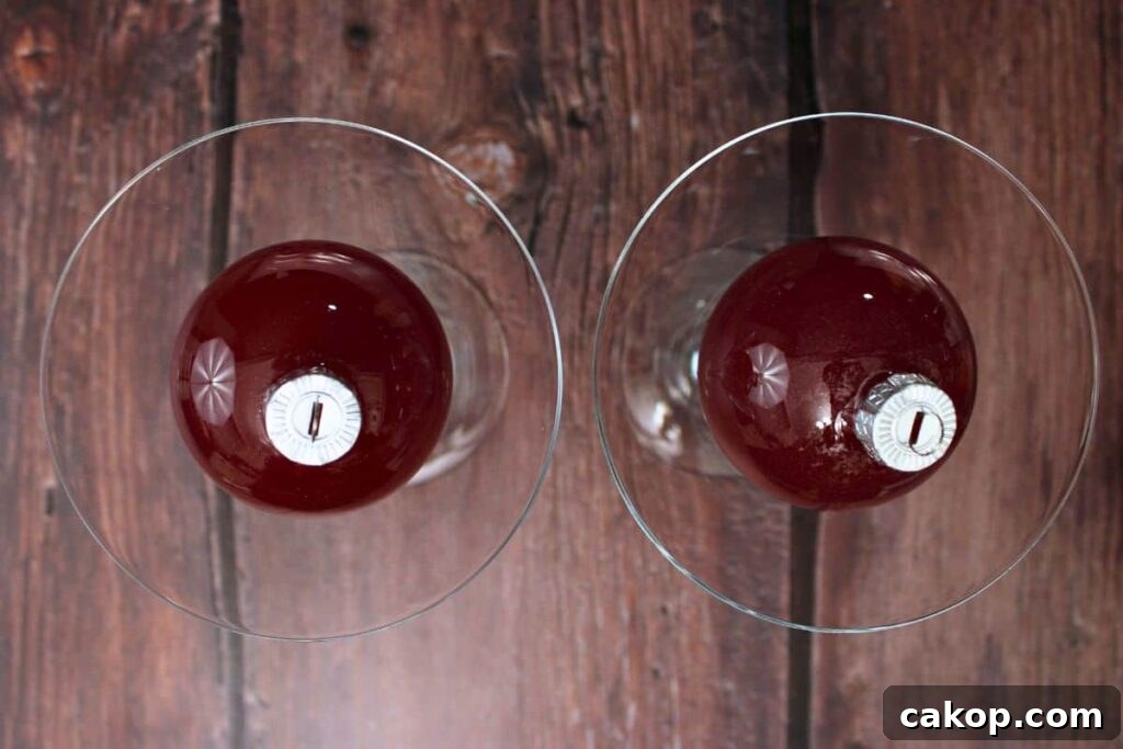 place the filled bauble on top of cranberries and rosemary in martini glass