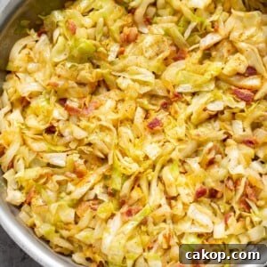 cabbage and bacon in a stainless steel skillet