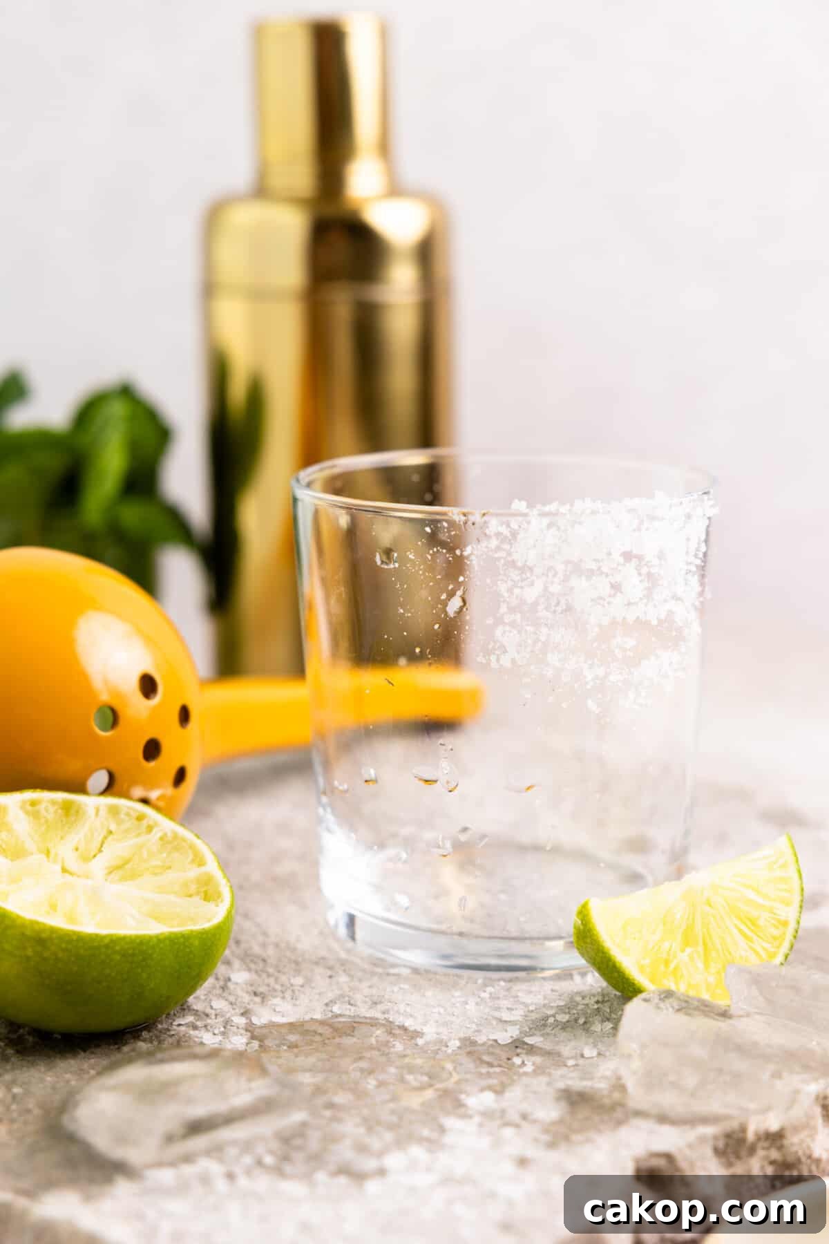Prepping a glass with salt on the rim for a margarita.