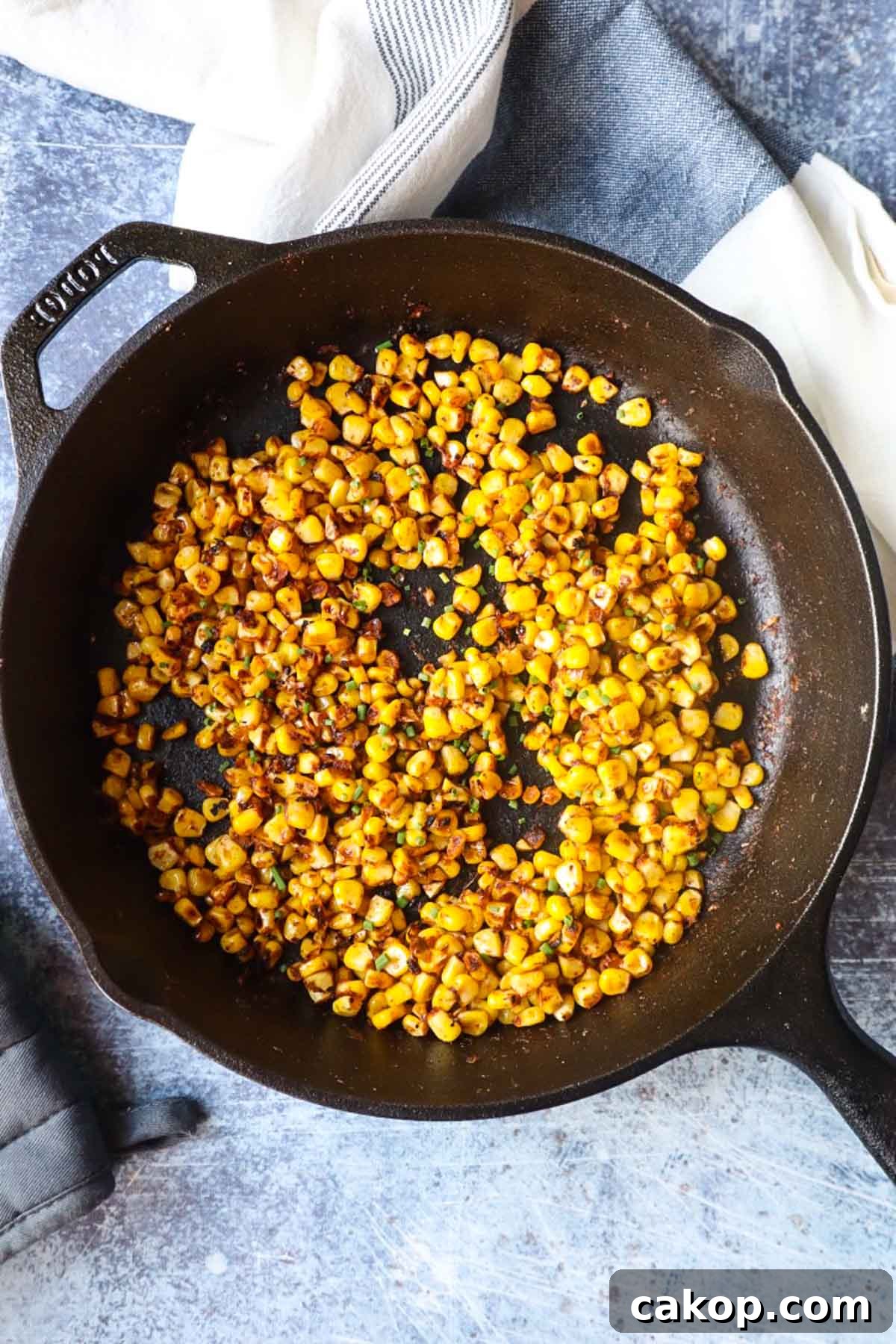 cast iron skillet with blackened corn and chives 
