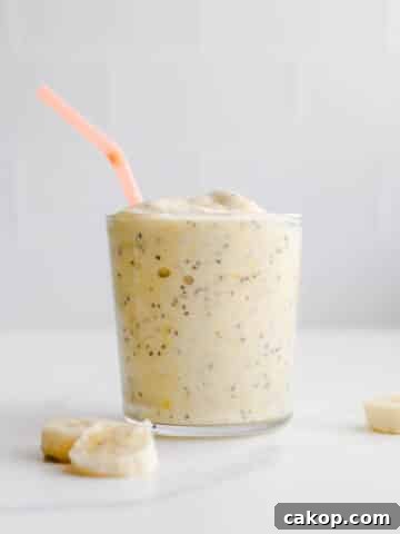 A smoothie with an orange straw.