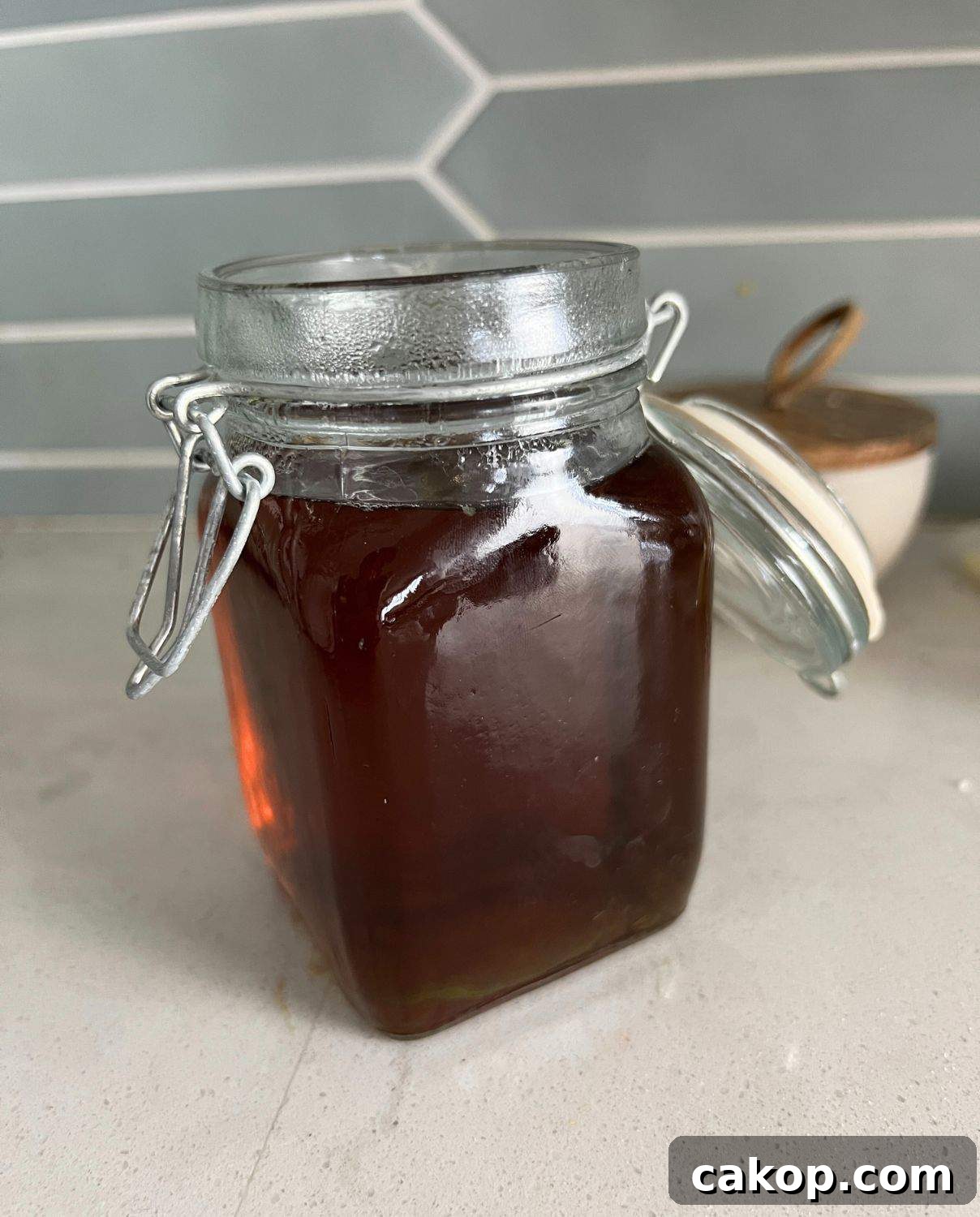 Sugar cookie syrup being poured into a jar. 