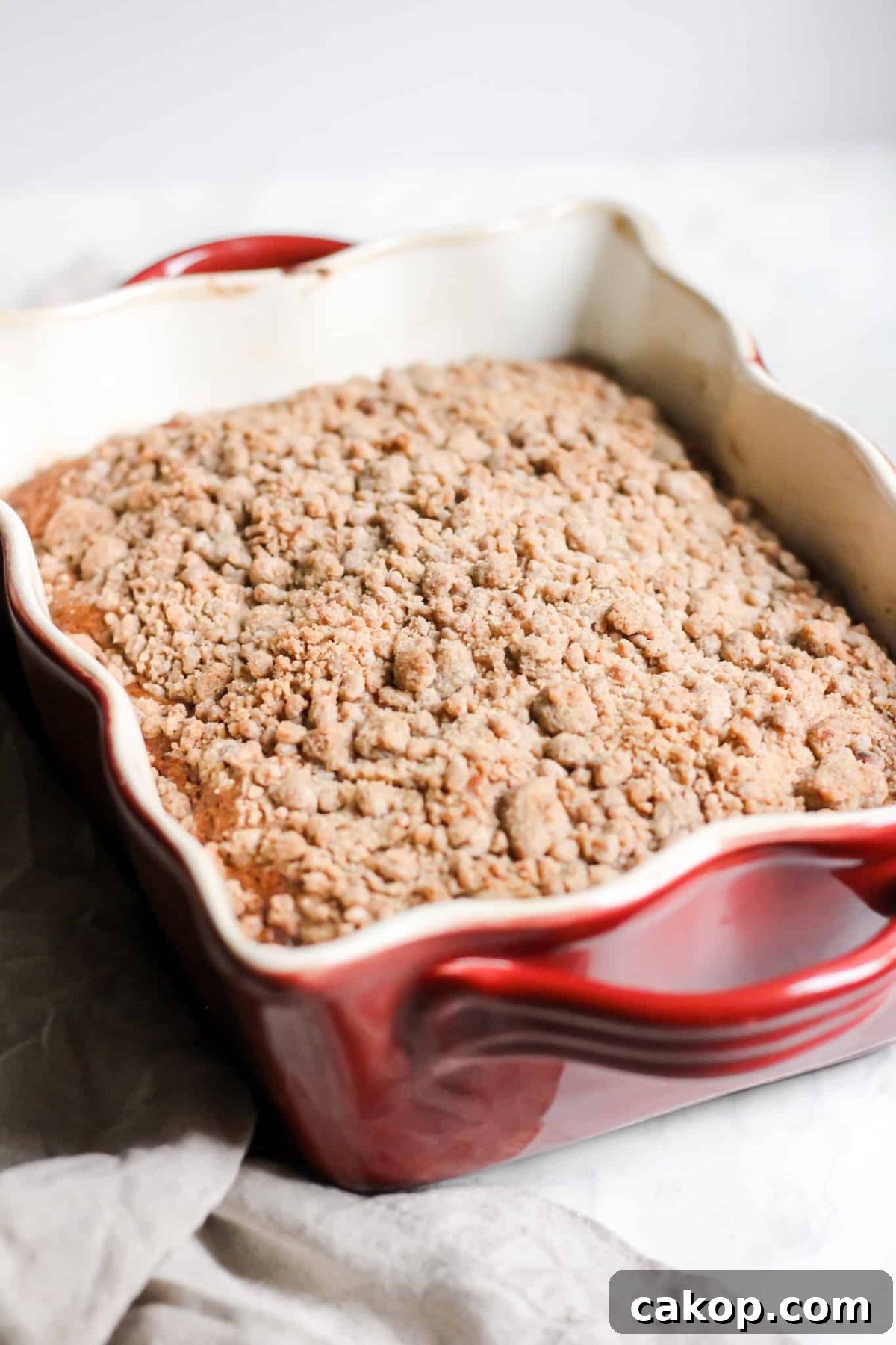 Healthier Cinnamon Sugar Apple Coffee Cake Healthier Breakfast Apple Cake with Cinnamon Sugar Crumble Topping and Maple Glaze in a Baking Dish